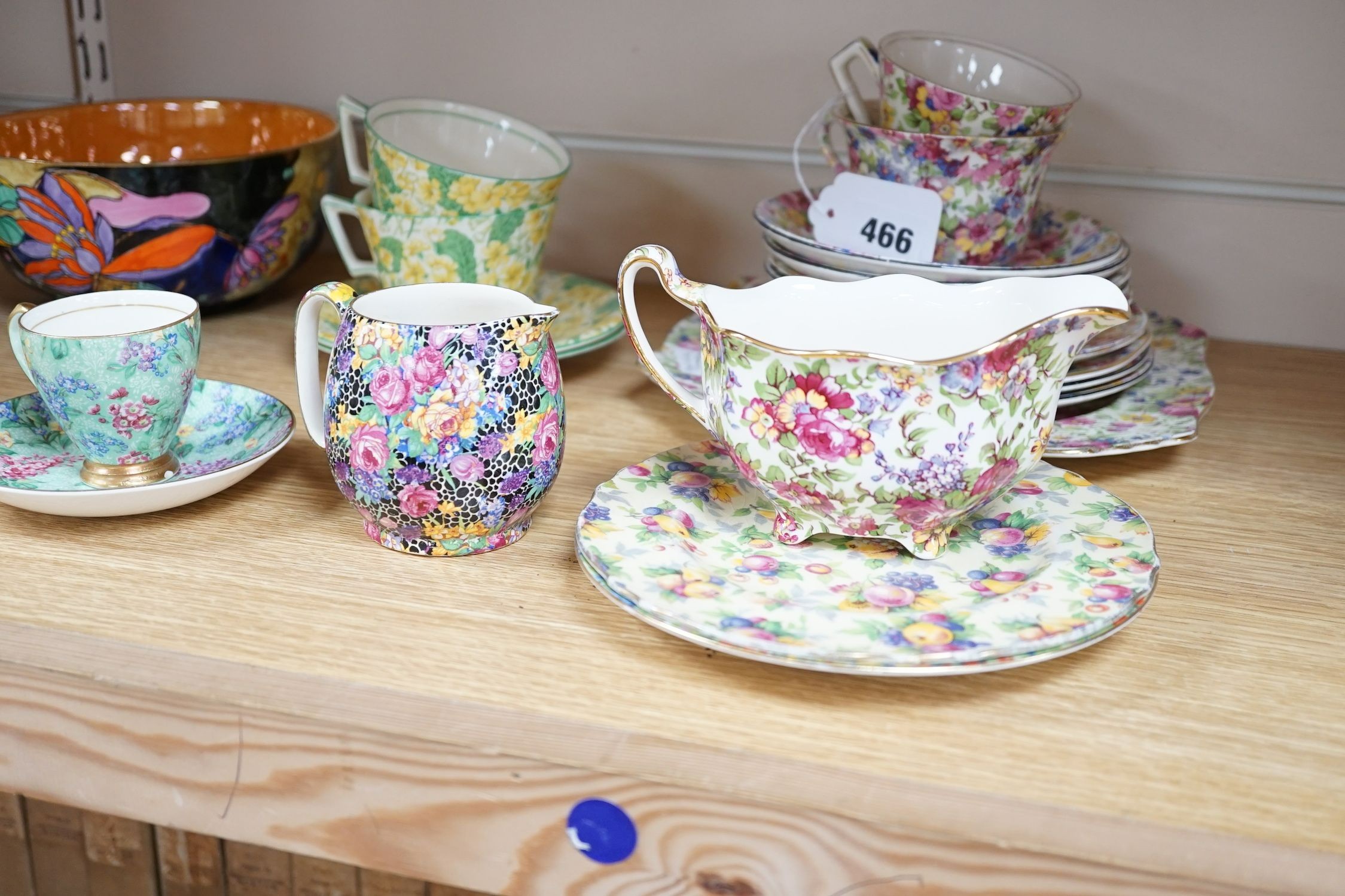 A Clarice Cliff tea cup, a collection of chintz patterned teaware, a lustre bowl and a honey pot and cover